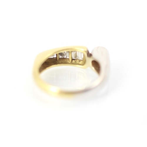 211 - A yellow and white metal diamond set dress ring, the round cut diamond set within white metal rub ov... 