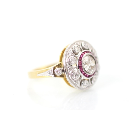 230 - An Art Deco style diamond and ruby target ring, the central round cut diamond within a surround of c... 