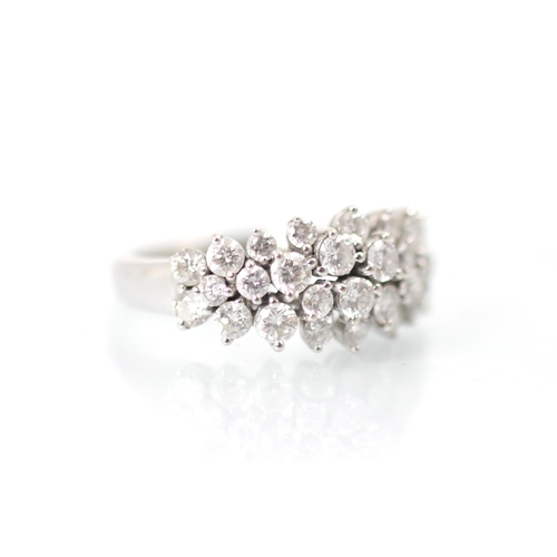 232 - A stylised diamond cluster ring, the graduated round cut diamonds set within a raised claw set mount... 