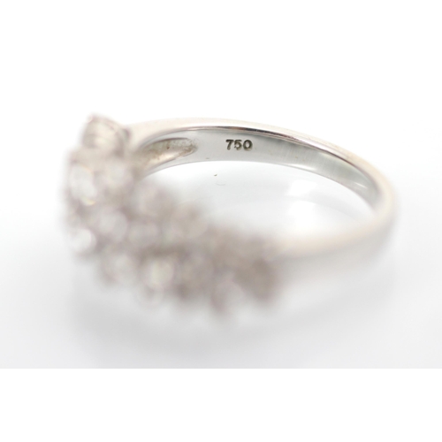 232 - A stylised diamond cluster ring, the graduated round cut diamonds set within a raised claw set mount... 