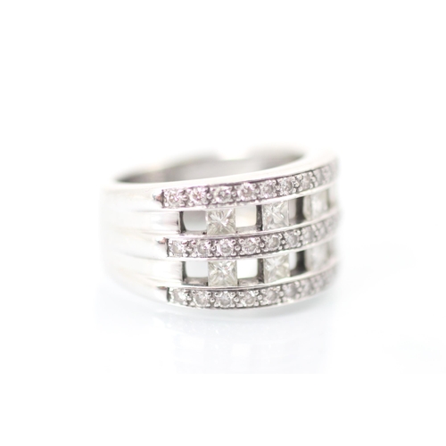 237 - A diamond dress ring, the ten princess cut diamonds channel set within triple border of round cut di... 