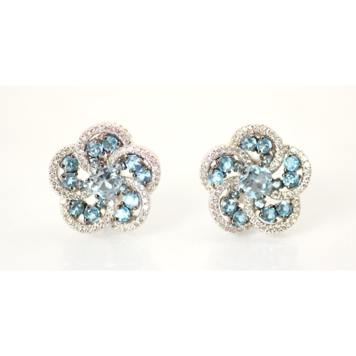 238 - A pair of blue topaz and diamond cluster earrings, the central round cut blue stone with an open wor... 