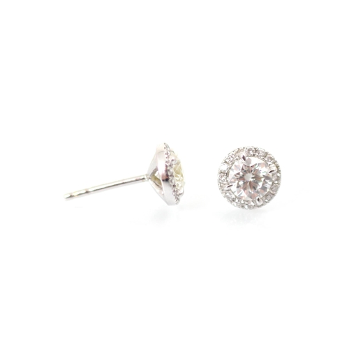 239 - A pair of diamond stud earrings, the round cut diamond within a surround of further smaller round cu... 