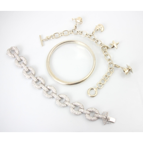 243 - A group of three bracelets, to include a Mappin and Webb charm bracelet, the curb links suspending c... 