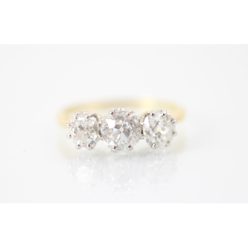 255 - A 20th century diamond three stone ring, the central old cut diamond with smaller old cut diamond to... 