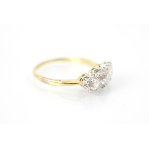 255 - A 20th century diamond three stone ring, the central old cut diamond with smaller old cut diamond to... 