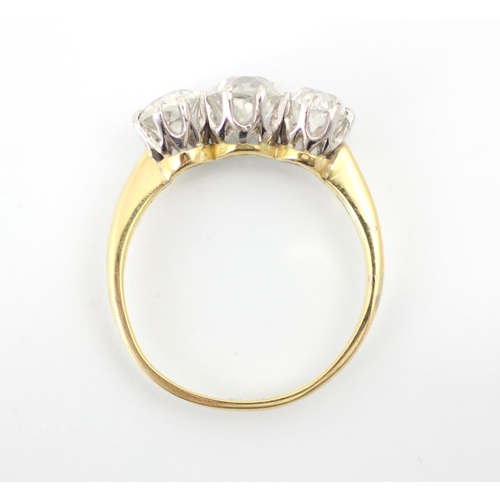 255 - A 20th century diamond three stone ring, the central old cut diamond with smaller old cut diamond to... 