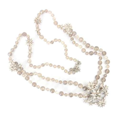 264 - A Chanel necklace, the starburst designed pendant set with white and light brown stones and Chanel d... 