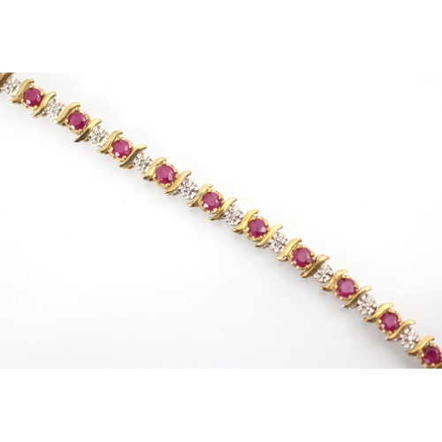 268 - A 9ct untested ruby and diamond bracelet, the round cut red stones with stylised bar interspersed wi... 