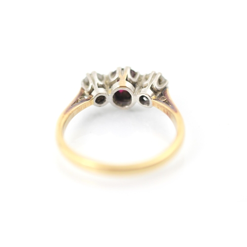 274 - An Edwardian style untested ruby and diamond three stone ring, the oval cut red stone within white m... 