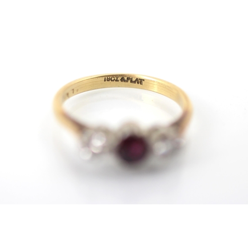 274 - An Edwardian style untested ruby and diamond three stone ring, the oval cut red stone within white m... 