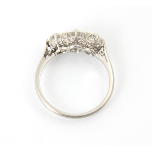 284 - An early 20th century diamond three stone ring, the central old cut diamond with smaller old cut dia... 