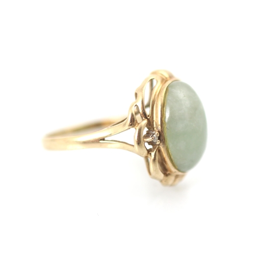 294 - A 9ct yellow gold green hardstone ring, the oval cabochon green stone within sinuous yellow gold mou... 