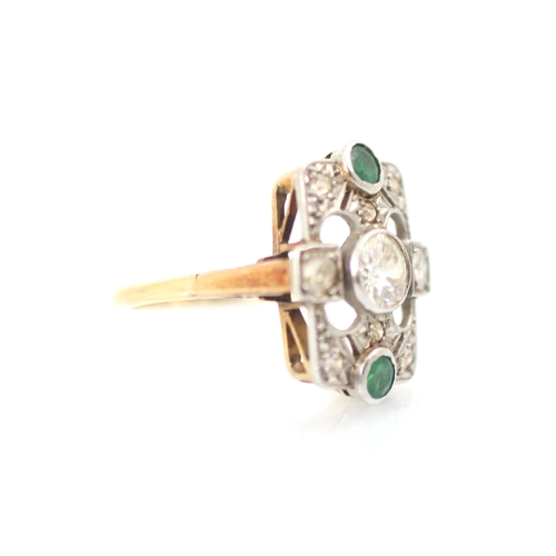 296 - A 20th century diamond and emerald ring, the central old cut diamond in white metal milgrain edge wi... 