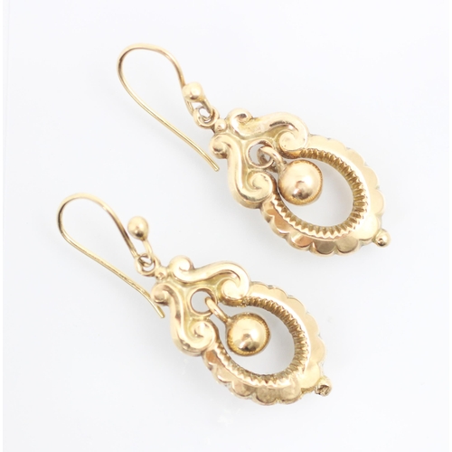 300 - A pair of Victorian style yellow metal earrings, the spherical hollow bead suspended within scallope... 