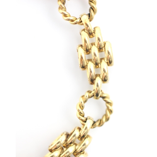 301 - A yellow metal fancy gate link bracelet, the lozenge shaped brick links interspersed with rope twist... 