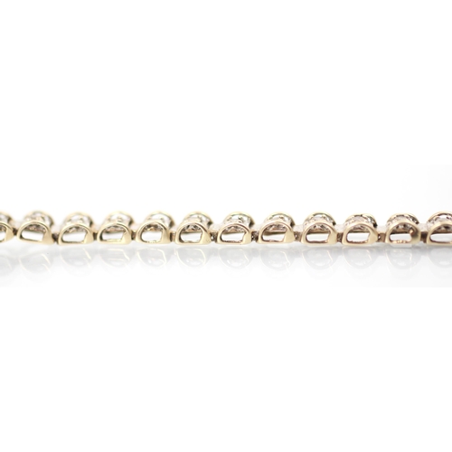 302 - A 9ct two tone diamond set bracelet, the white metal square shaped links set with round cut diamonds... 