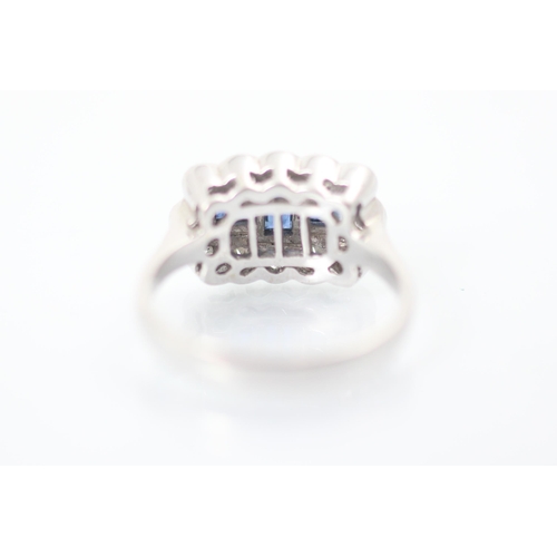 303 - An 18ct white gold sapphire and diamond dress ring, the three baguette cut sapphires within surround... 