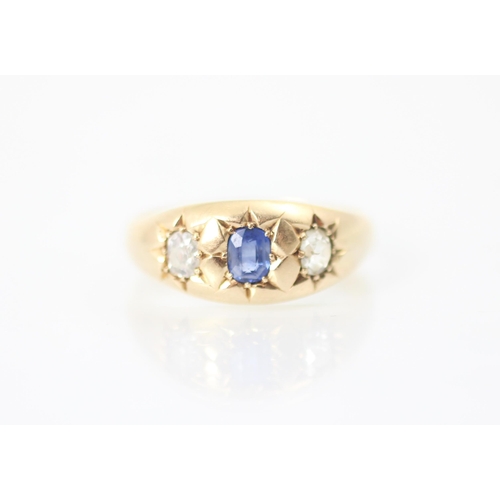 312 - A 19th century untested sapphire and diamond three stone ring, the central cushion cut blue stone wi... 