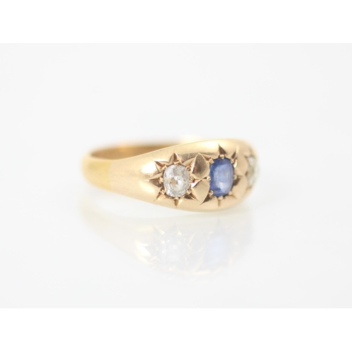 312 - A 19th century untested sapphire and diamond three stone ring, the central cushion cut blue stone wi... 