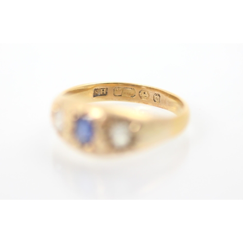 312 - A 19th century untested sapphire and diamond three stone ring, the central cushion cut blue stone wi... 