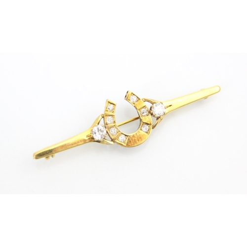 315 - A yellow metal diamond set bar brooch, the round cut diamonds set within a horse shoe designed head ... 