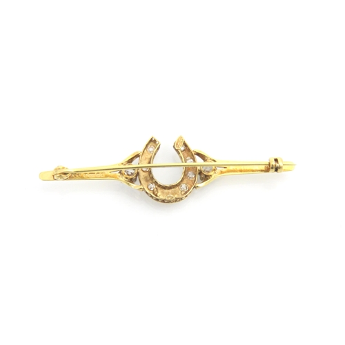 315 - A yellow metal diamond set bar brooch, the round cut diamonds set within a horse shoe designed head ... 