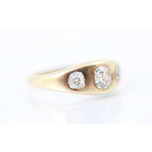 323 - An early 20th century yellow metal and diamond three stone gypsy set ring, the central old cut diamo... 