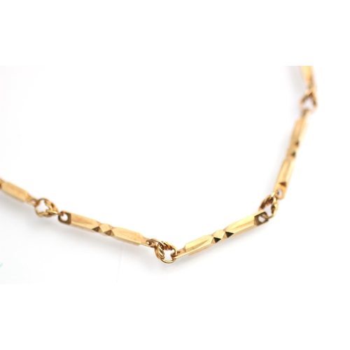 329 - A yellow metal necklace, the shaped faceted rectangular links interspersed with circular stylised li... 