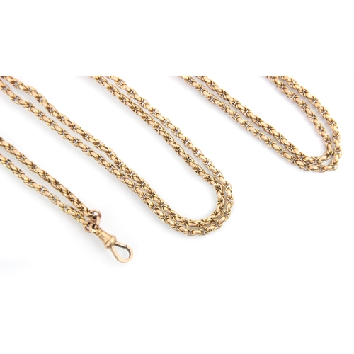 333 - A 20th century yellow metal long guard chain, the lightly faceted links suspending associated yellow... 