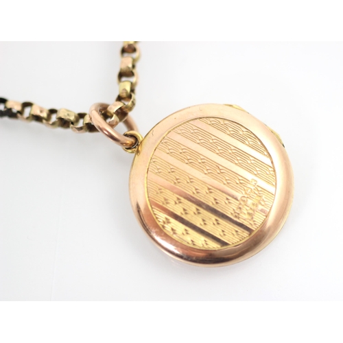 334 - An early 20th century 9ct yellow gold locket pendant, the engine turned decorated circular pendant o... 