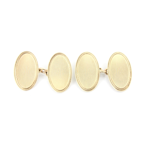 336 - A pair of 9ct yellow gold cufflinks, the oval links with stylised sun ray decoration, stamped to rev... 