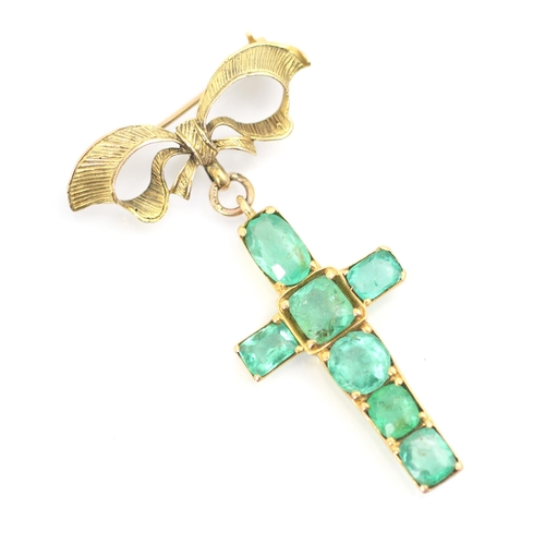 337 - A 20th century emerald set cross pendant/brooch, the mixed cut emeralds within yellow metal claw set... 