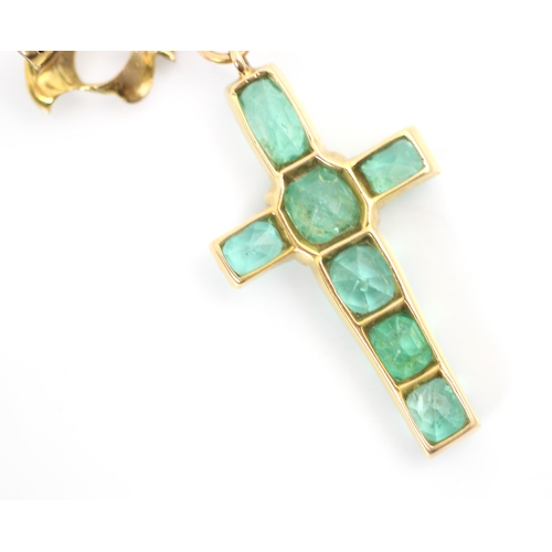 337 - A 20th century emerald set cross pendant/brooch, the mixed cut emeralds within yellow metal claw set... 