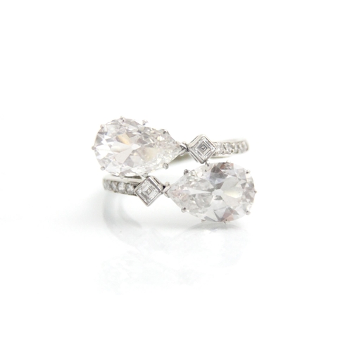 338 - A 20th century old cut pear cut diamond ‘toi et moi’ ring, the two old cut pear cut diamonds claw se... 