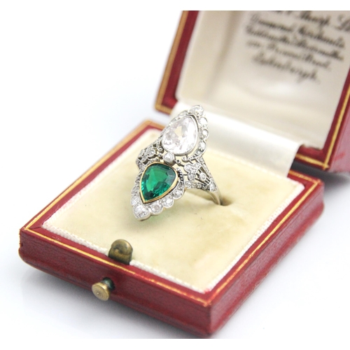 339 - A ‘Belle Epoque’ emerald and diamond set ring, the old cut pear cut diamond within white metal milgr... 