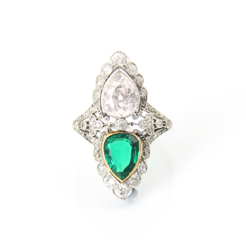 339 - A ‘Belle Epoque’ emerald and diamond set ring, the old cut pear cut diamond within white metal milgr... 