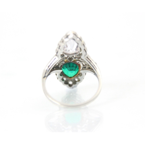 339 - A ‘Belle Epoque’ emerald and diamond set ring, the old cut pear cut diamond within white metal milgr... 