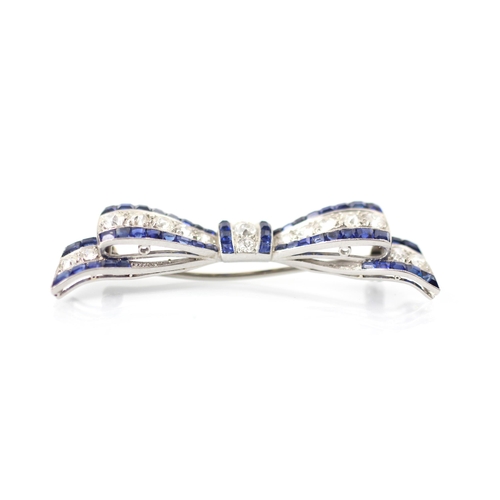 340 - An early 20th century sapphire and diamond ribbon brooch, the central line of old cut diamonds with ... 