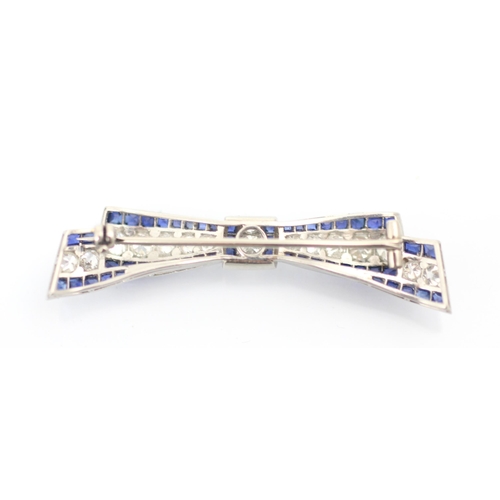 340 - An early 20th century sapphire and diamond ribbon brooch, the central line of old cut diamonds with ... 