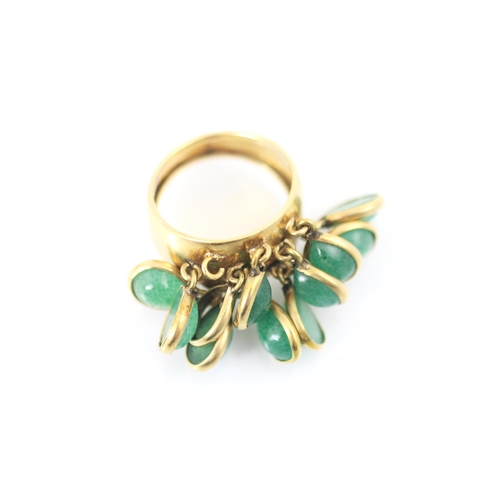 343 - A yellow metal and green stone dress ring, the wide tapered band suspending ten tear drop shaped cab... 