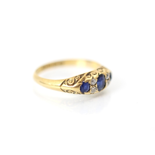 354 - An Edwardian untested sapphire and diamond ring, the central oval cut blue stone with a smaller blue... 