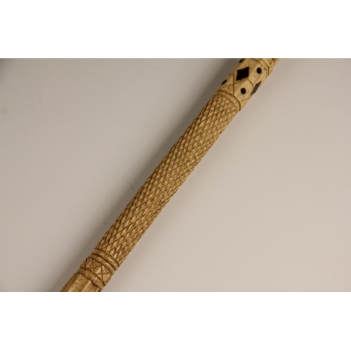 394 - A carved whalebone scrimshaw walking cane, mid 19th century, of gently curved tapering form, the pol... 