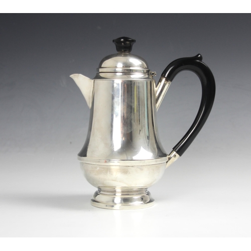 44 - A silver hot water jug, Aaron Lufkin Dennison Birmingham 1935, of tapering cylindrical form with ebo... 