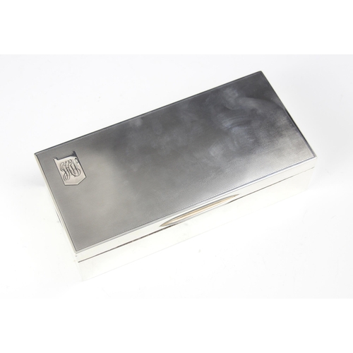 53 - A George VI silver cigarette box, Padgett and Braham Ltd, London 1937, the hinged cover with engine ... 
