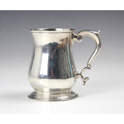 59 - A George II silver mug, Thomas Parr II, London 1752, the scroll handle above baluster body with engr... 