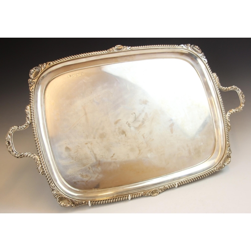 77 - An Edwardian silver tray, Elkington and Co, Birmingham 1908, the cast gadroon rim with shell detail ... 