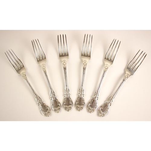 80 - A set of six 19th century French silver table forks, the scrolling decorated spoon with initial to r... 