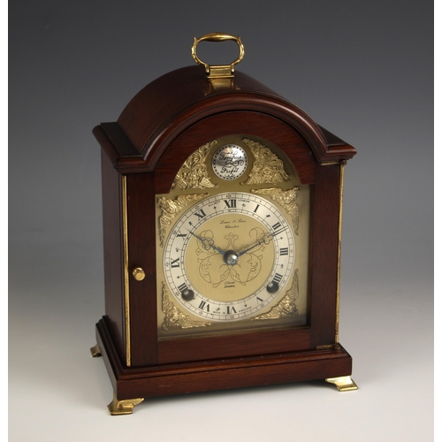 A mahogany cased Elliot mantel clock, retailed by Lowe and Sons, Chester, the arched case enclosing