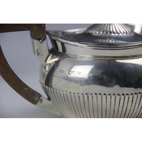 91 - An Edwardian silver teapot, Walker and Hall, Birmingham 1900, the shaped rim about plain polished bo... 